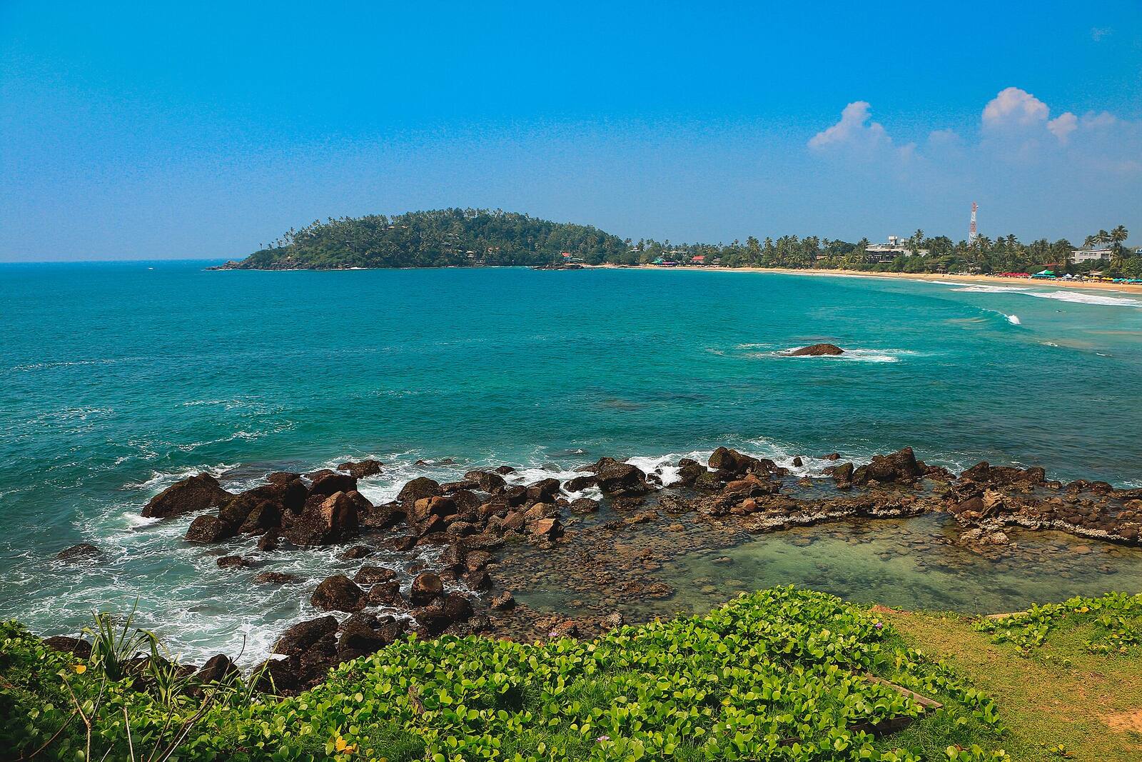 The view over Mirissa bay and Parrot Rock from the rocks above the beach