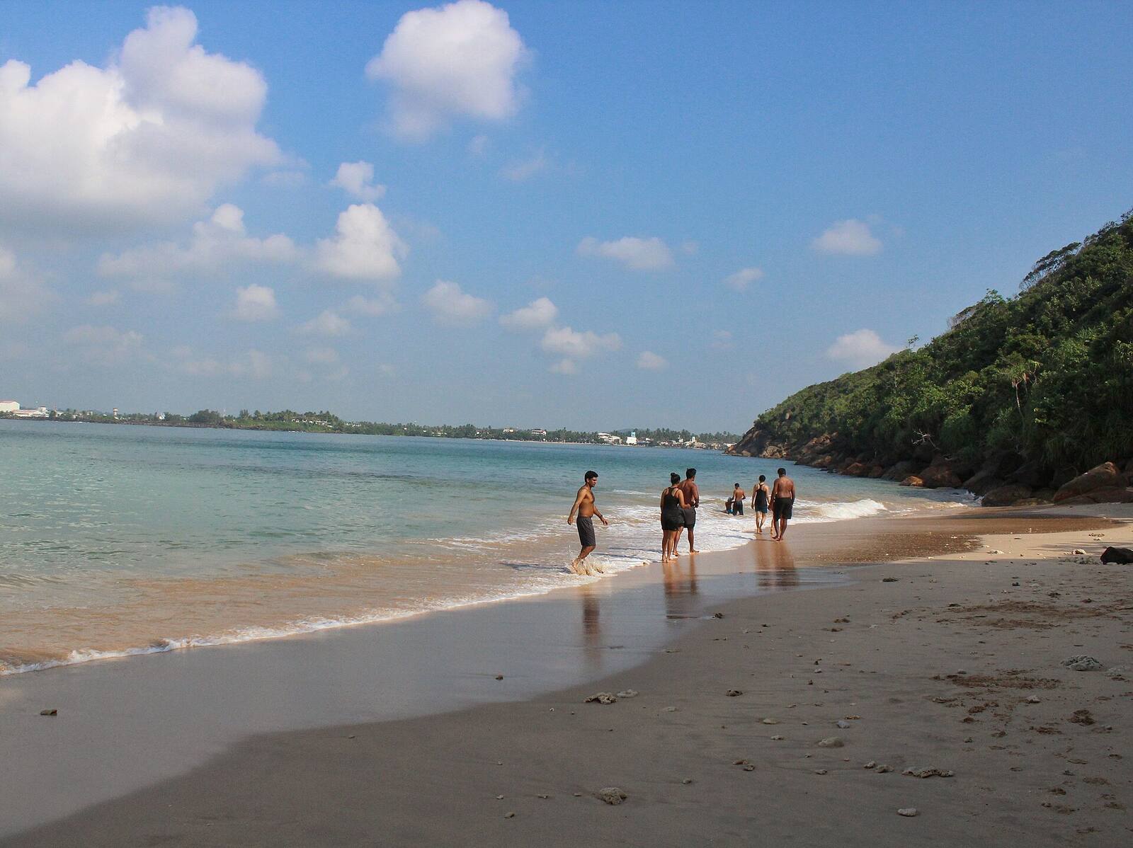 Swimmers in the calm water of Unawatuna bay