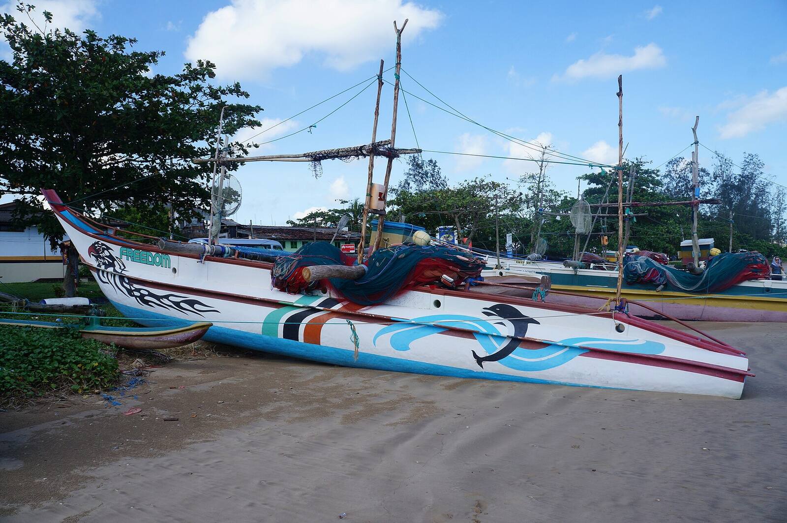 Painted outrigger fishing boats on the sand at Weligama