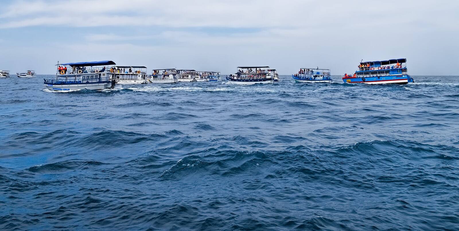 Whale watching boats heading out to sea off Mirissa